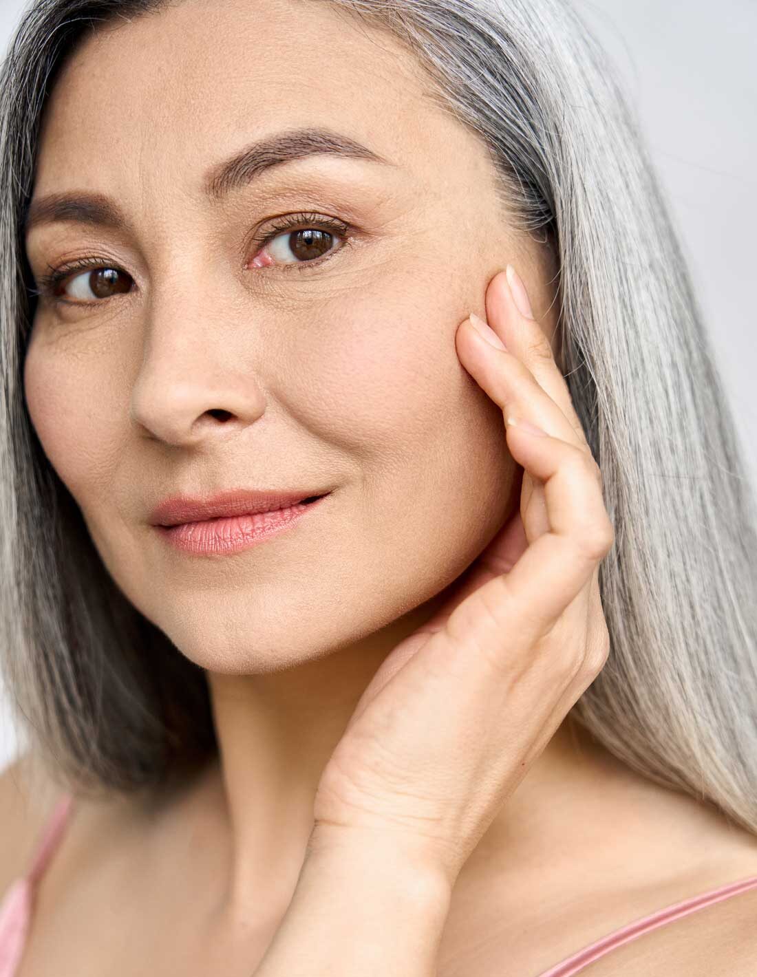 Woman showing radiant skin after Fire & Ice facial
