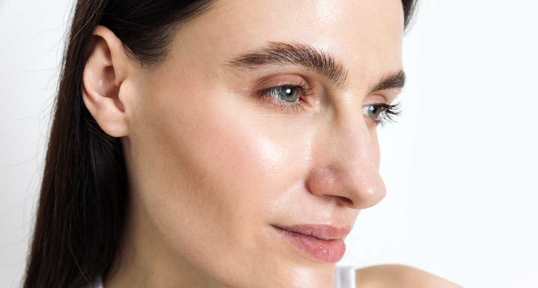 Woman showing glowing skin after a DiamondGlow® facial