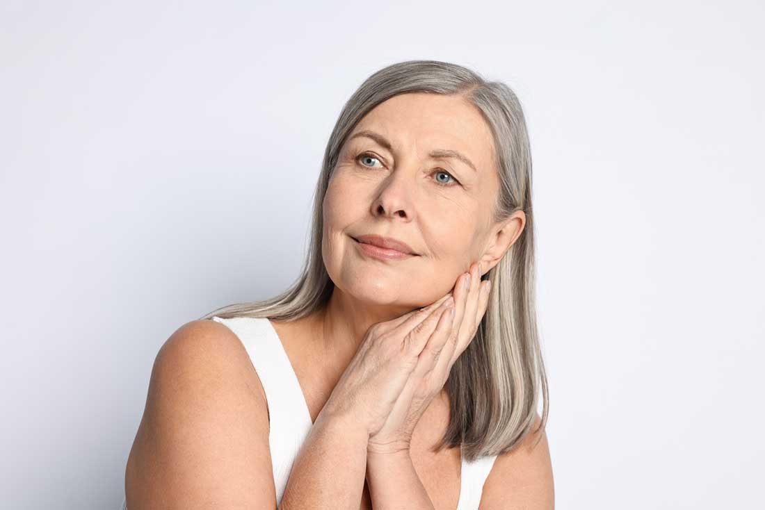 Woman enjoying refreshed skin after dermaplaning treatment