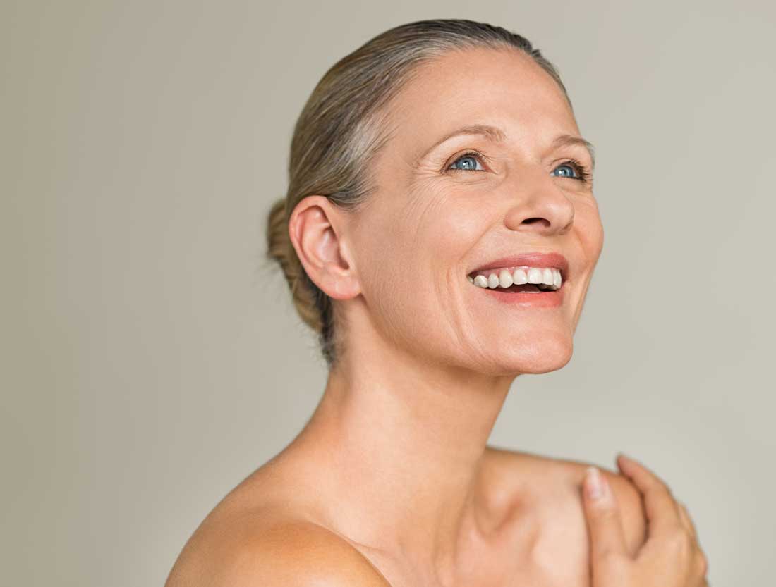 Smiling woman receiving a DiamondGlow® facial in Charleston